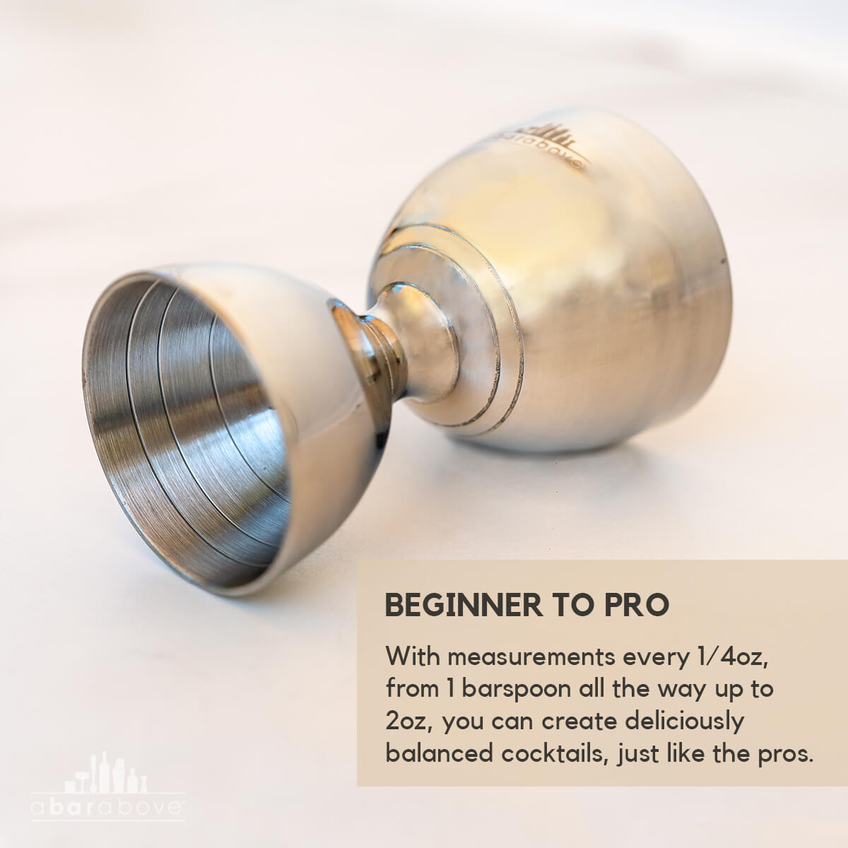 Labeled feature graphic for a stainless steel bell jigger, highlighting its precise measurements for balanced cocktails (details in description).