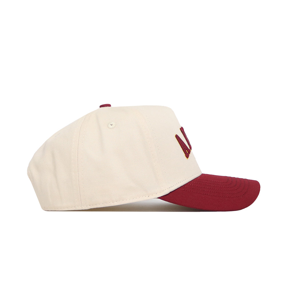 The No Rivals Ames Hometown Hat features a cream-colored snapback with a maroon brim and maroon embroidered lettering, crafted from high-quality cotton and shown in side profile against a white background.