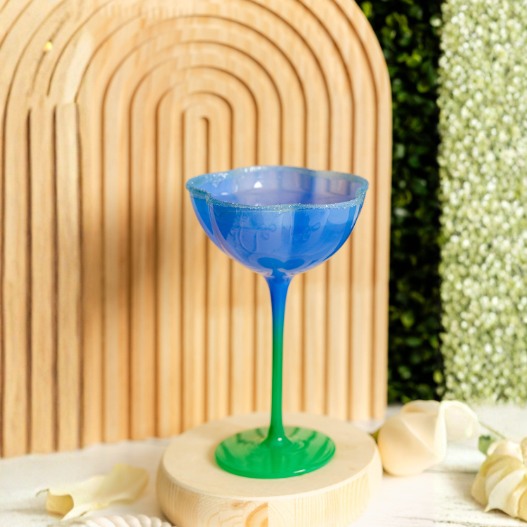 Blue and green glass on a wooden stand with a blurred natural background