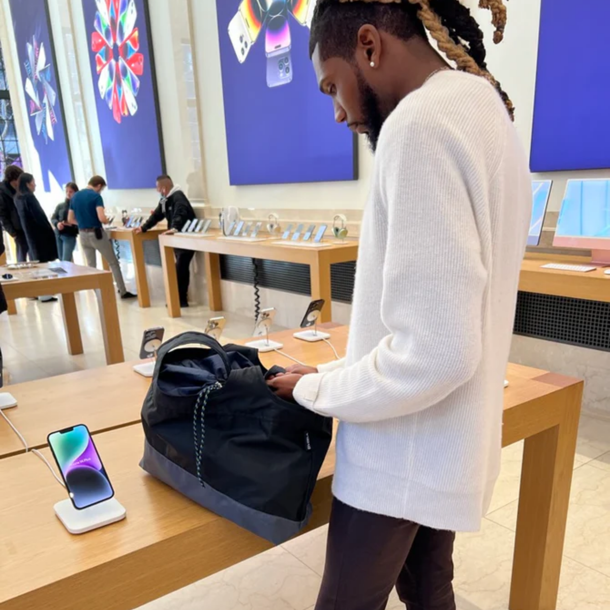 Packable, foldable, reusable bag made from recycled ocean plastic by BYBBA, displayed in a tech store.