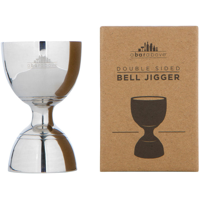 Polished stainless steel bell jigger stands next to its brown cardboard box packaging.