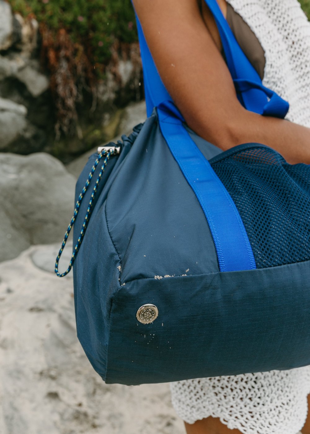 underneath corner of navy duffle tote