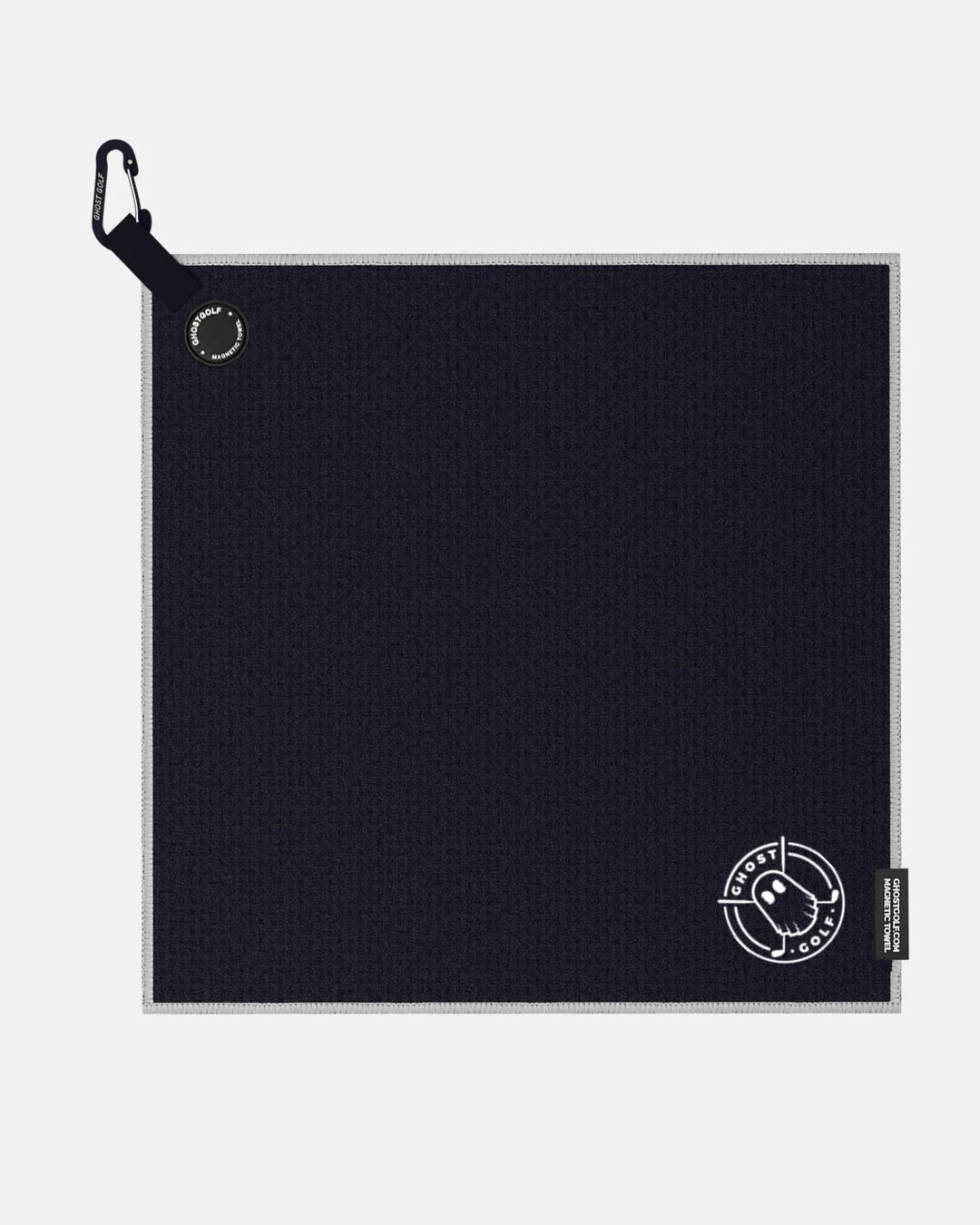 Product shot of Black Ghost Golf Magnetic Greenside Towel with emblem logo near the bottom and carabiner clip at the top #color_black