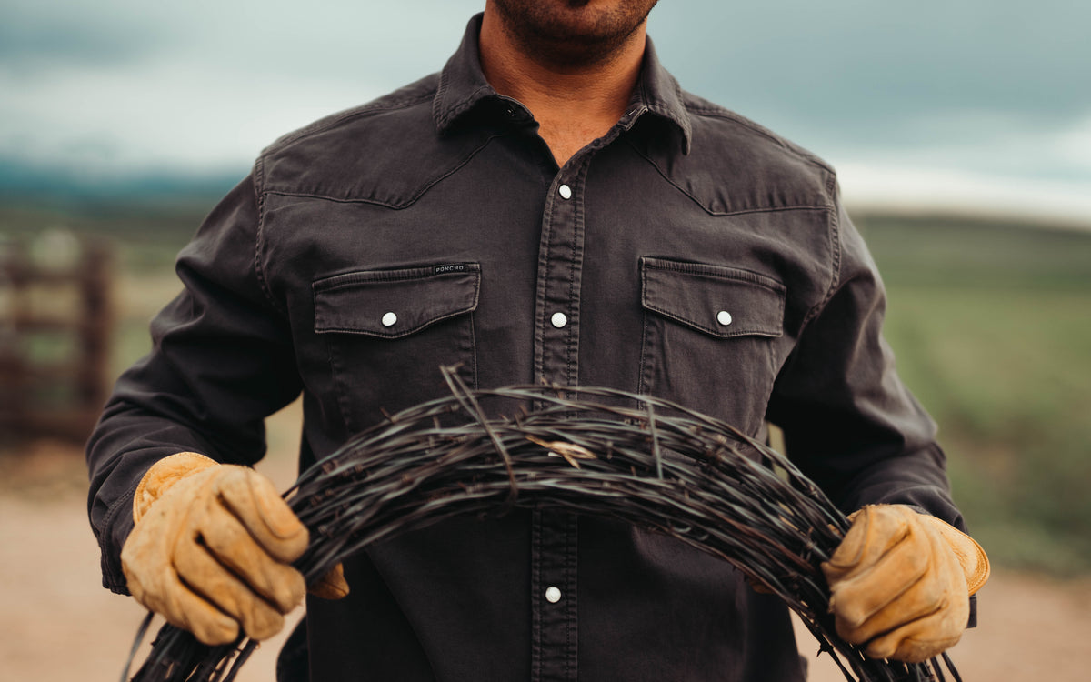 man holding barbed wire wearing the matamorros shirt