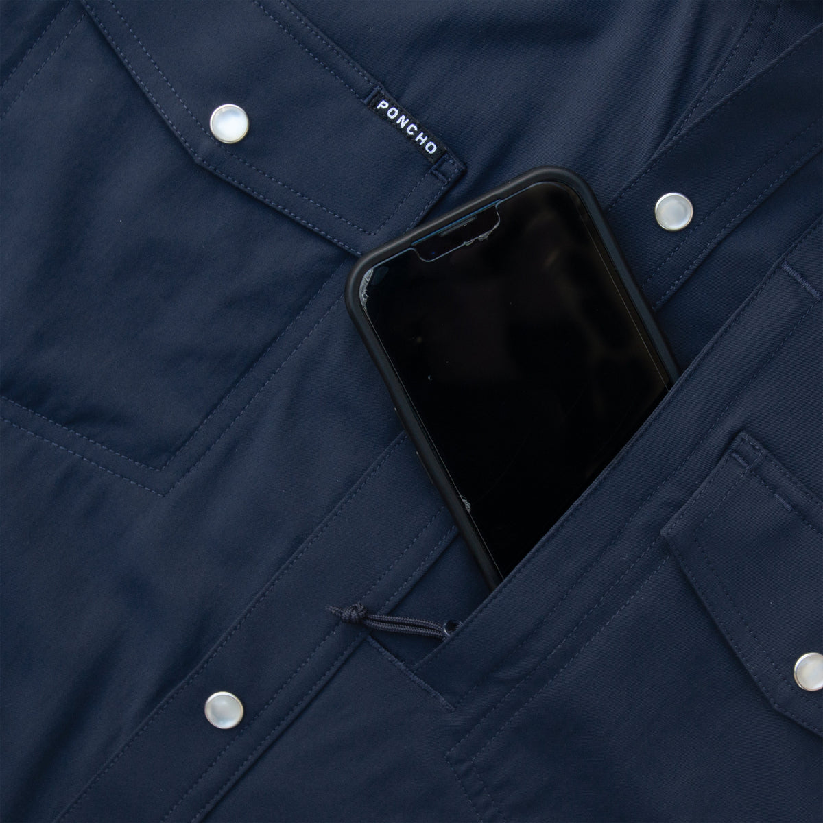 closeup navy shirt with phone going into pocket