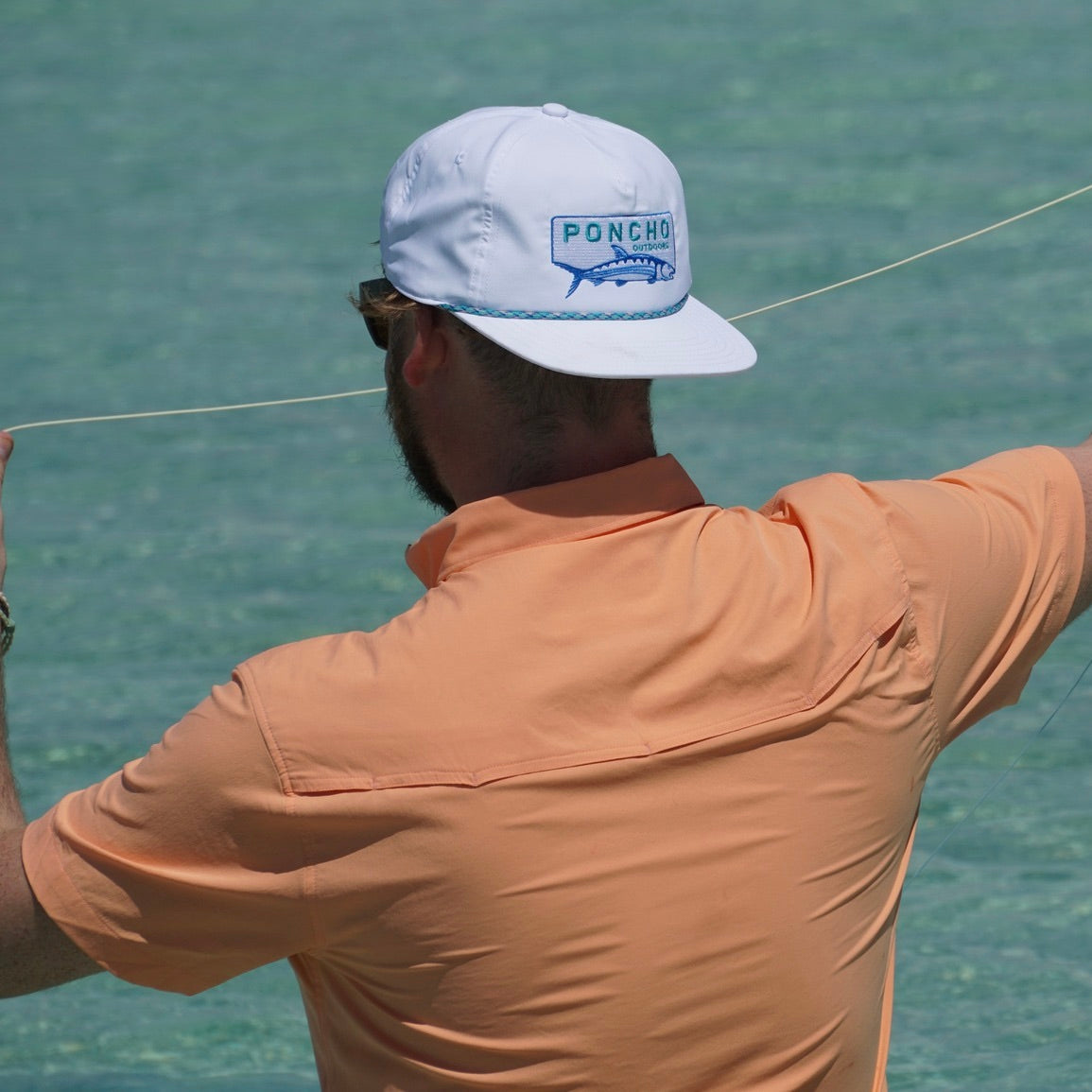 man fishing with orange short sleeve shirt