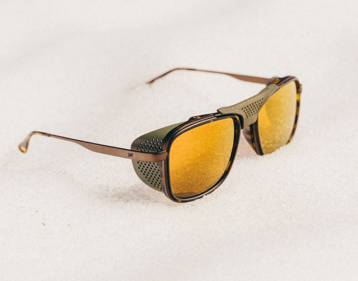 STORY Sunglasses with gold lenses and brown frame on a white background