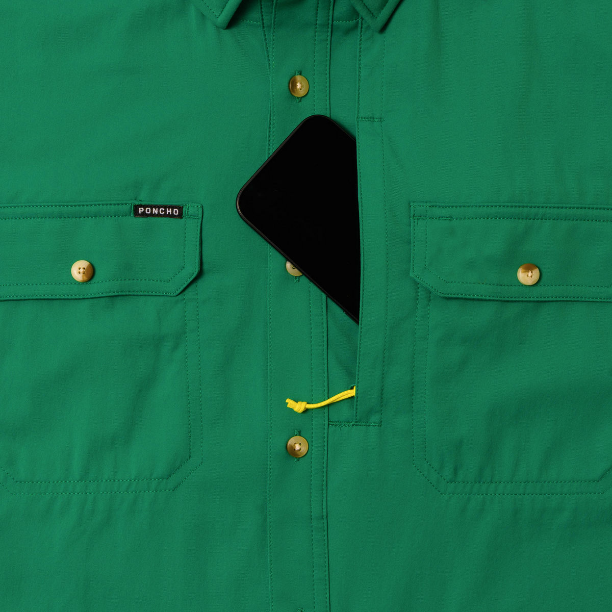 phone in chest zipper pocket of green shirt