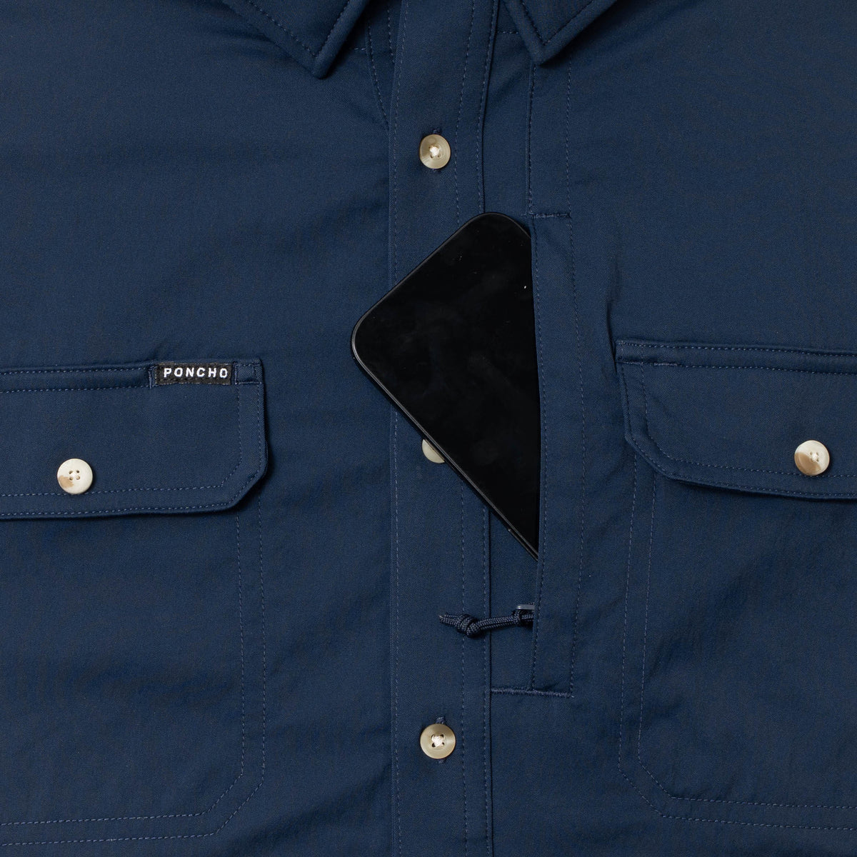 photo of navy shirt with phone in zipper pocket