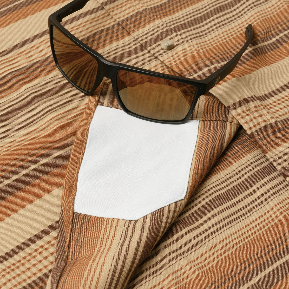 sunglasses with lens cleaner on shirt