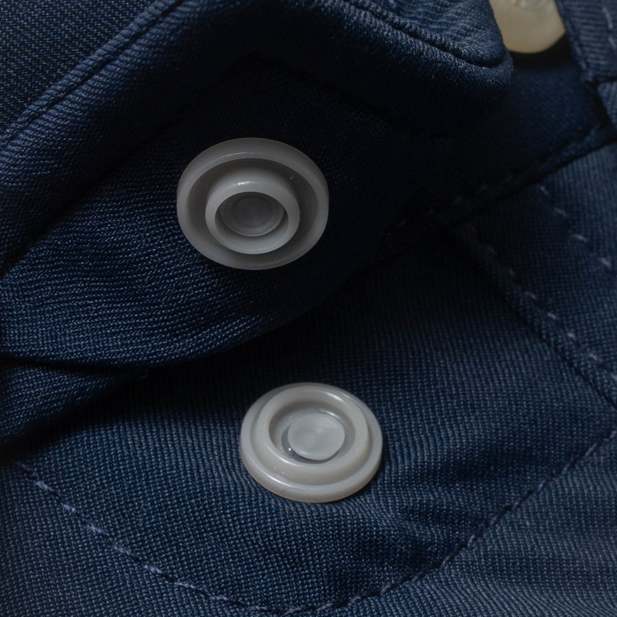 photo of collar snap on navy shirt