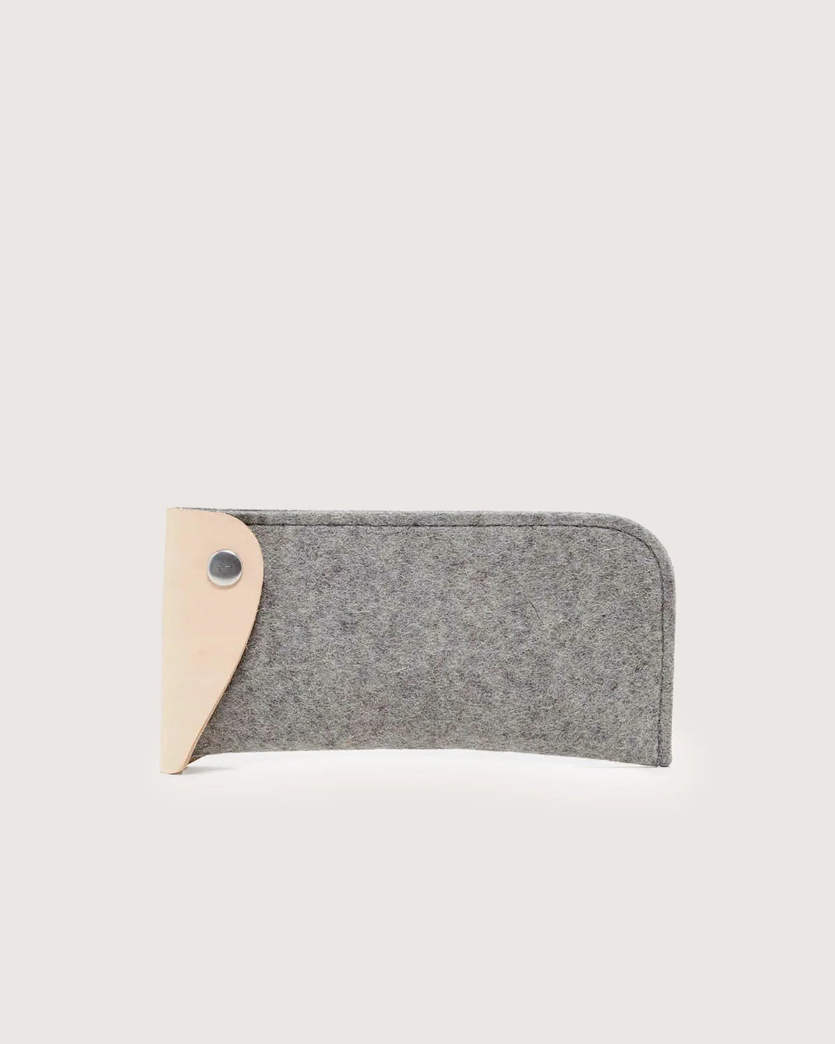 A gray felt graf lantz eyeglass sleeve with rounded edges is shown on a white background, featuring a light brown Merino wool leather flap and a metal snap button closure on the left side.