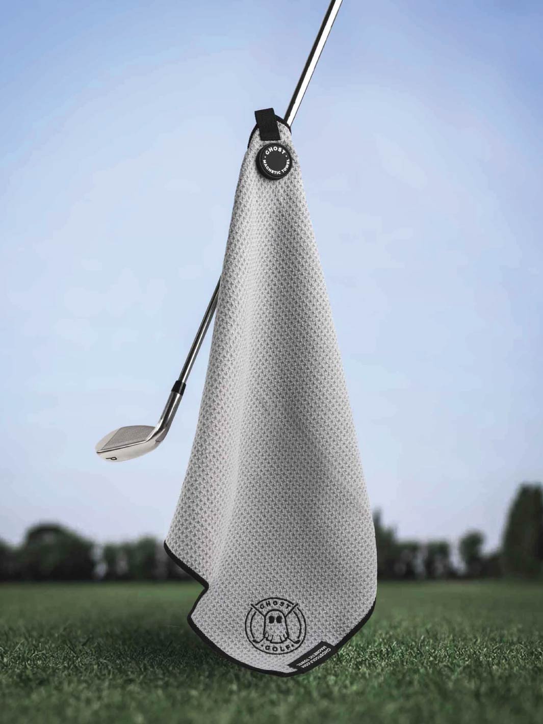 Greenside Towel with Magnet Patch and Carabiner. Light Grey. Towel is stuck on Golf Club with Green and Sky background. #color