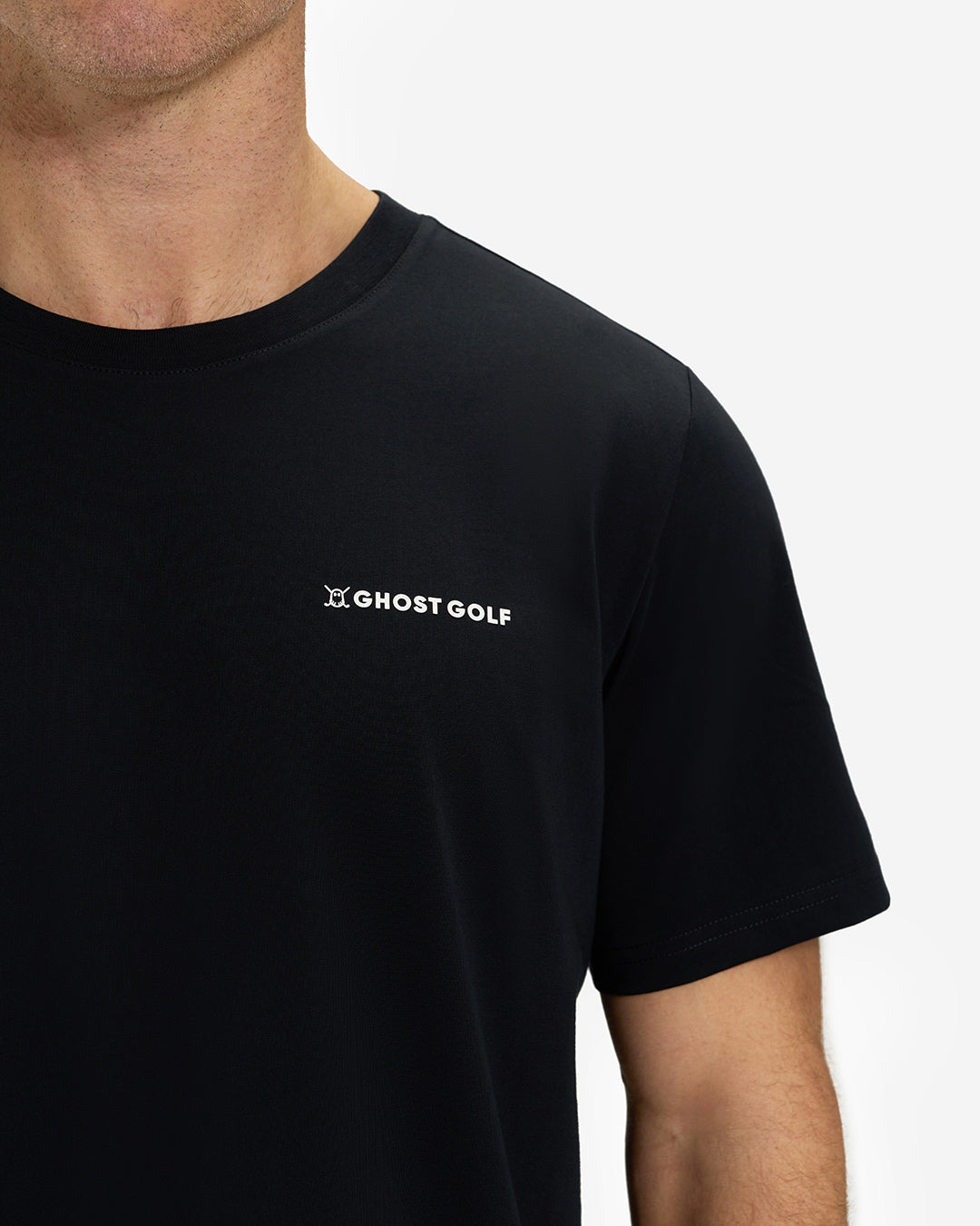 Front Closeup View of Black Ghost Golf Core Logo Tee on White Male Model #color_black