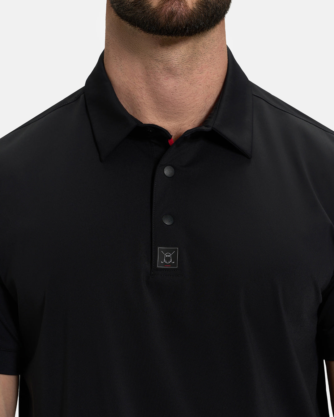 Front Closeup View of Black Ghost Golf Core Polo on White Male Model #color_black
