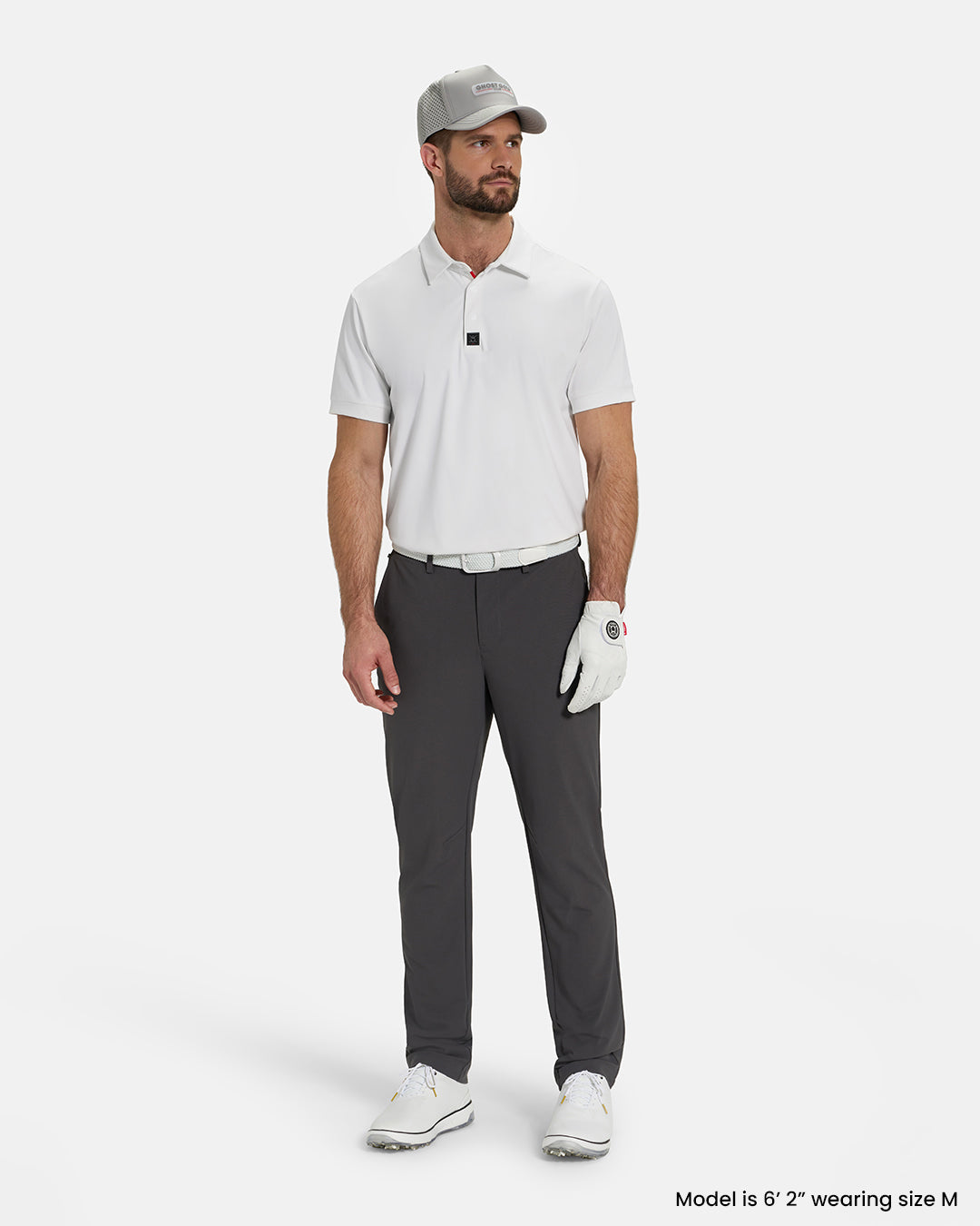 Full Body View of Optic White Ghost Golf Core Polo Tucked on White Male Model wearing grey pants white gloves white belt white shoes and grey hat #color_white