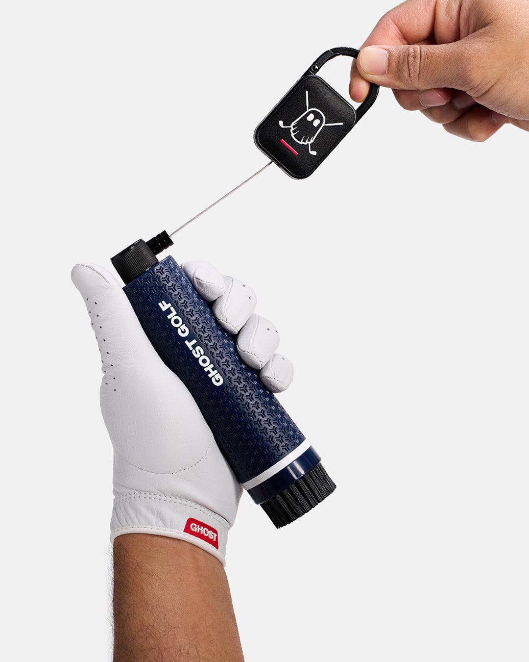 Golfer with White Glove holding a Navy Ghost Golf club and shoe cleaning brush with a magnetic back and Carabiner attached to it#color_navy