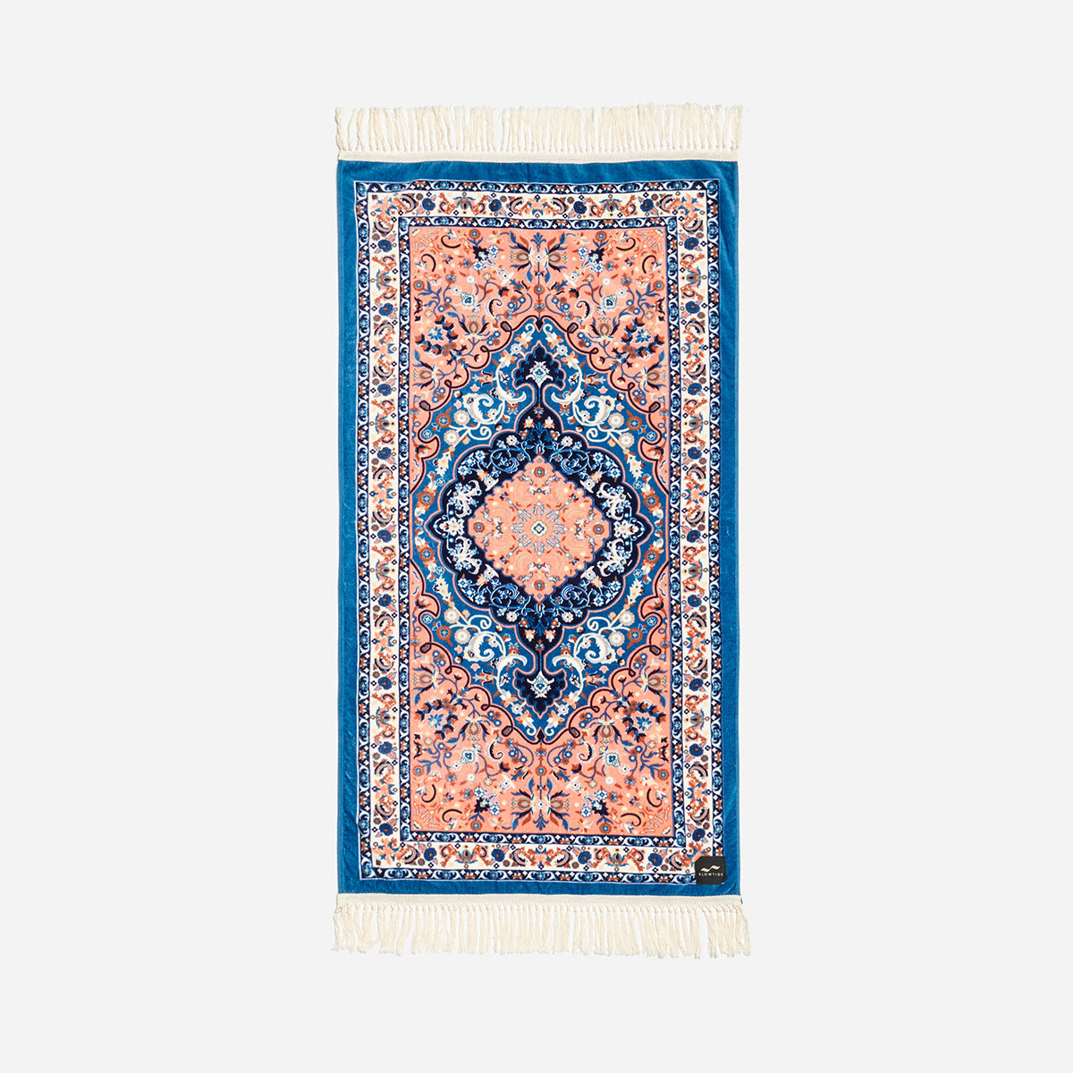 A beach towel with a printed velour front featuring a geometric pattern in a mix of blue and orange hues, with a terry looped back, displayed against a white background.
