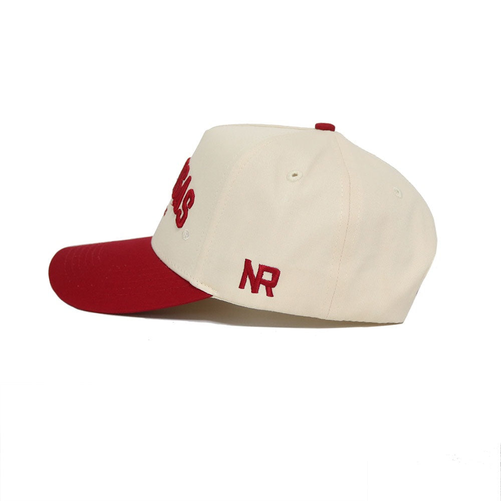 The Arkansas Razorback Hat by No Rivals features a cream base, red brim, top button, and side NR embroidery. "Cardinals" appears in red on the front. Includes a Snap Back Adjustment for your perfect fit.