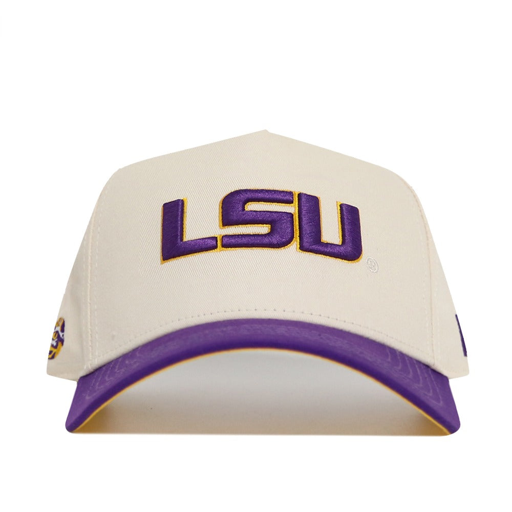 The No Rivals Classic LSU Hat (B2B) is a cream-colored cotton cap with LSU embroidered in purple and gold, a purple brim with gold accent underside, and an adjustable snap back for a comfortable fit.