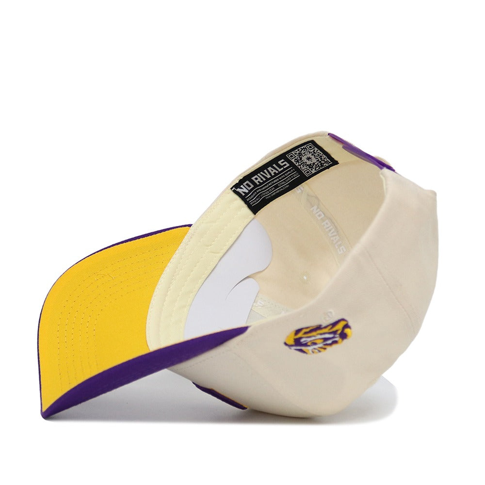 The Classic LSU Hat by No Rivals is a beige and purple cotton baseball cap, shown upside down to reveal its yellow brim underside. It features a NO RIVALS inner tag, embroidered tiger logo on the back, and adjustable snap back.
