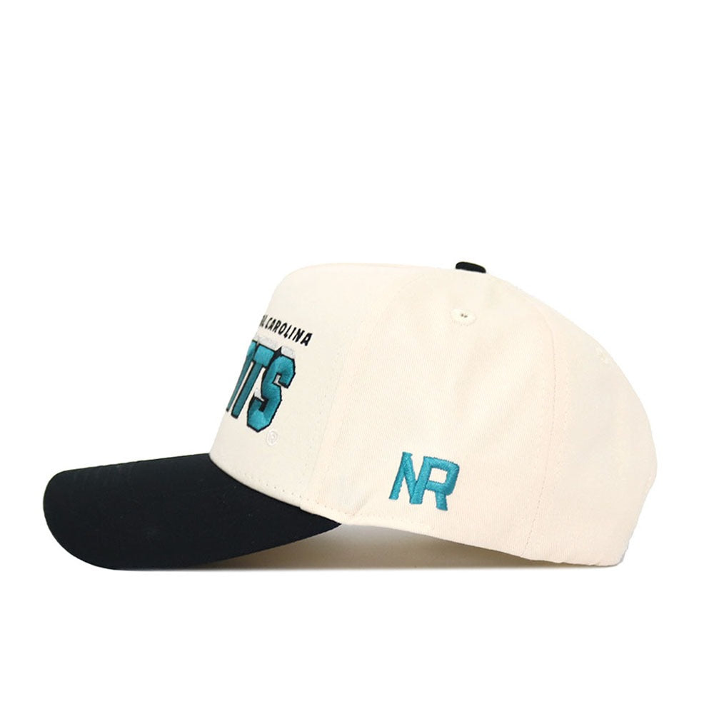 The No Rivals Coastal Carolina Alma Mater Hat - Classic (B2B) is a white cotton snapback cap with a black brim, featuring teal and black "NR" embroidered on the side and front, shown against a plain white background.