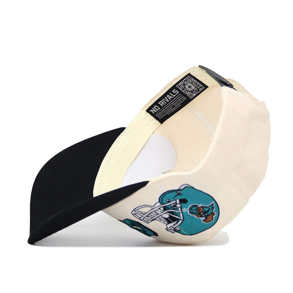 The Coastal Carolina Alma Mater Hat - Classic by No Rivals is a cream and black snapback baseball cap with a cartoon dog on a motorcycle, "NO RIVALS" inner label, and made from high quality cotton for lasting comfort.