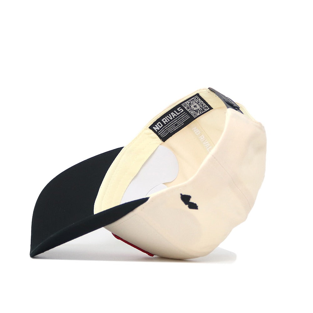 A cream and black Classic Rutgers Hat (B2B) by No Rivals is shown inside out, revealing a NO RIVALS label, QR code, small black lips logo on the side, a black visor, and a visible inner cotton lining.