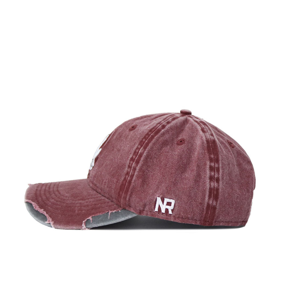 A side view of the Arizona State Denim Hat, a maroon washed cotton dad hat with a distressed brim and seams. Features an adjustable back and white "NR" embroidery on the side near the rear.