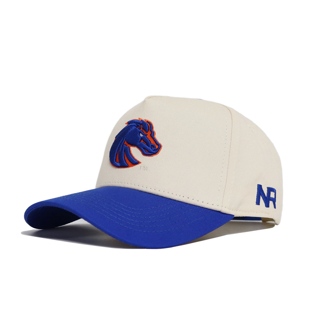 The Classic Boise State Hat (B2B) by No Rivals is a beige snapback with a blue brim, featuring a blue and orange horse head logo and "NR" stitched in blue—perfect for your gameday fit.