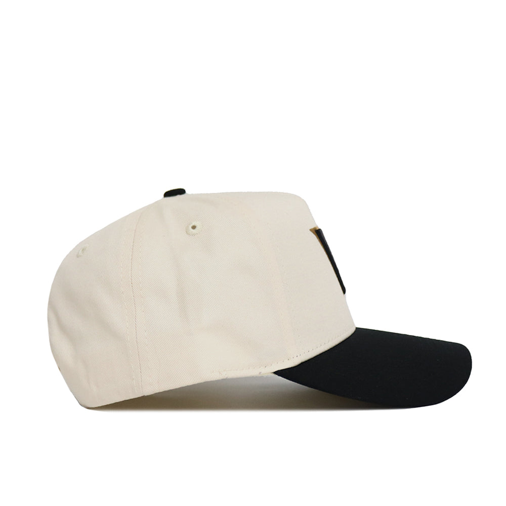 A side view of the No Rivals Classic Vanderbilt Hat (B2B), a beige snapback with a black curved brim, displayed on a white background—ideal for your gameday look.