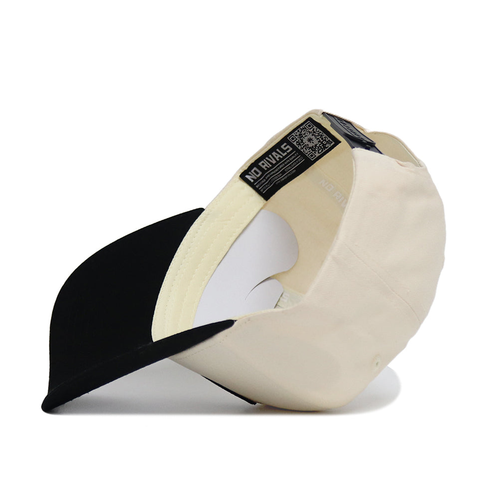 The Classic Vanderbilt Hat (B2B) by No Rivals is displayed upside down, showing its inner lining, QR code label, and a NO RIVALS tag inside—an ideal addition to your gameday look.