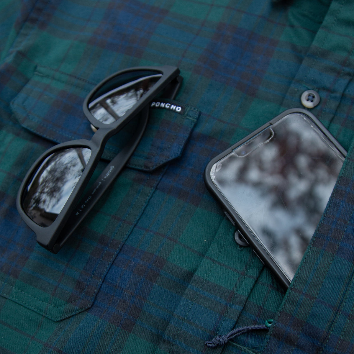 sunglasses and phone in shirt