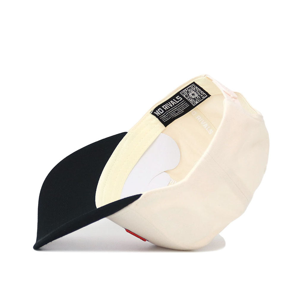The Clemson Letterman Hat by No Rivals is shown upside down, displaying its cream cotton exterior, black bill, interior stitching, and a label with a QR code and the text NO RIVALS.