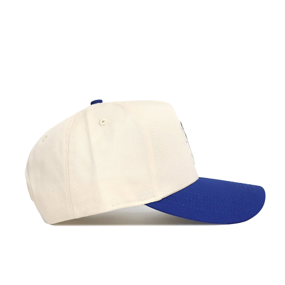 The Classic University of Memphis Hat (B2B) by No Rivals is a cream baseball cap with a royal blue curved brim, made from high quality cotton, displayed in a side profile on a white background.
