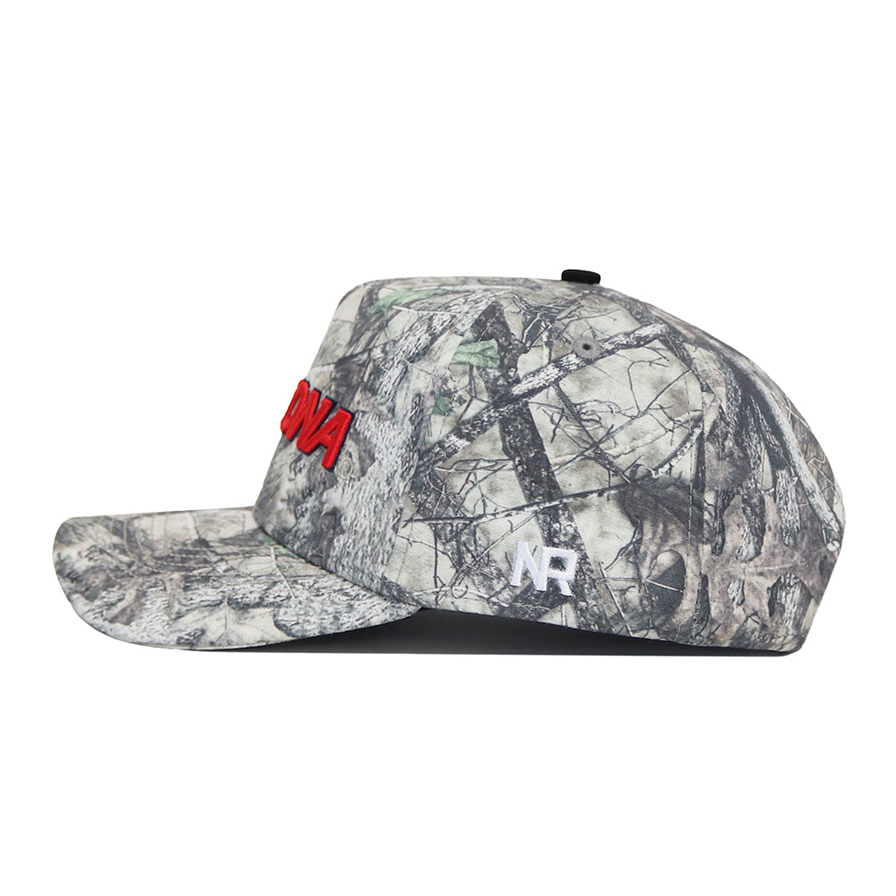 The No Rivals Arizona Outland Hat is a camouflage cotton baseball cap with red embroidered front text, a white NR side logo, and snap back closure, shown in side profile.