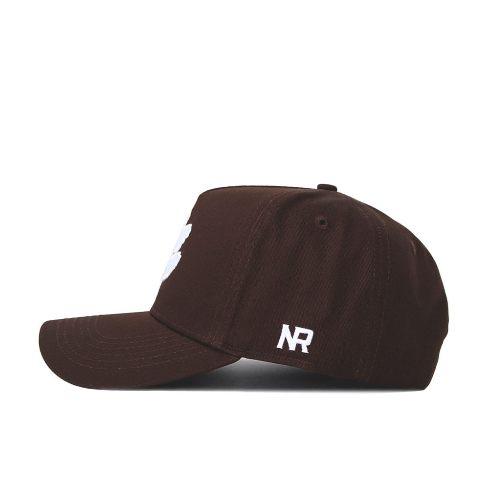 A side view of the Clemson Americano Hat, a brown baseball cap with a white NR logo above the brim. Made from high-quality cotton, it features a flat bill, structured crown, and snapback adjustment for a perfect fit.