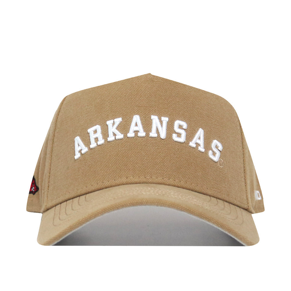 The Arkansas Rustic Hat is a tan cotton-canvas baseball cap with "ARKANSAS" embroidered in large white letters on the front and a structured fit for lasting shape.