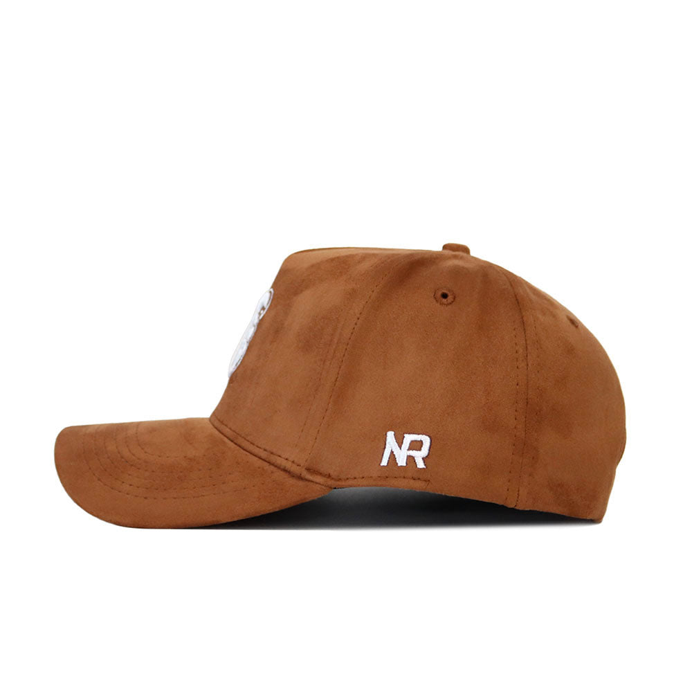Side view of the No Rivals Coastal Carolina Heritage Hat, an officially licensed brown suede baseball cap with white embroidered NR on the side, curved brim, and visible stitching details.