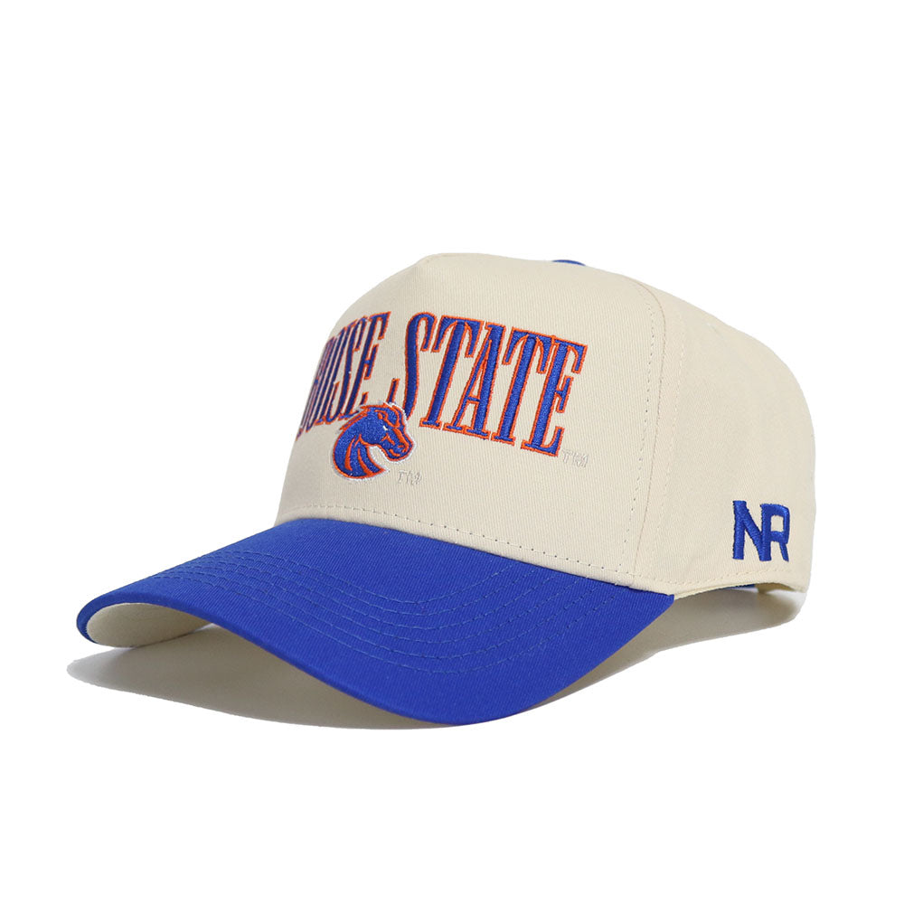 The Boise State Retro Block Hat by No Rivals features Boise State’s horse logo on high-quality cotton in beige and blue, with NR embroidered on the side. This officially licensed snapback cap offers an adjustable, comfortable fit.