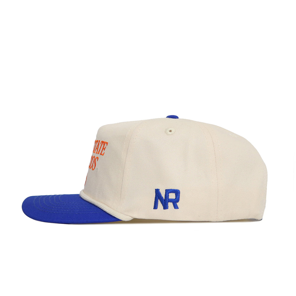 The No Rivals Boise State Old School Hat (B2B) is cream with a blue brim and top button, featuring blue "NR" embroidery on the side. It offers an unstructured fit and an adjustable snapback for one-size-fits-most comfort.