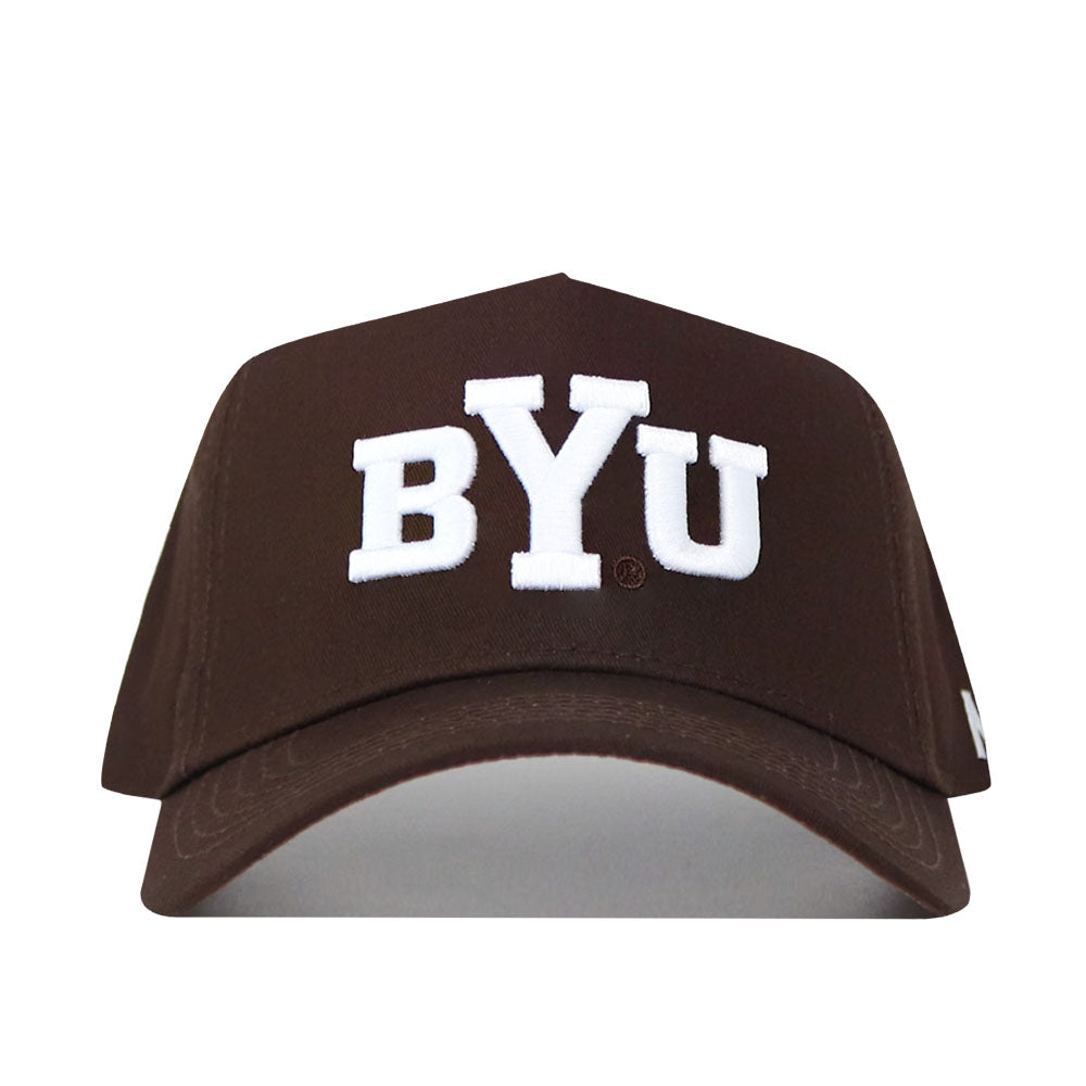 The BYU Americano Hat is a brown baseball cap with large white BYU letters embroidered on the front, featuring a structured fit and an adjustable snapback closure for comfort.