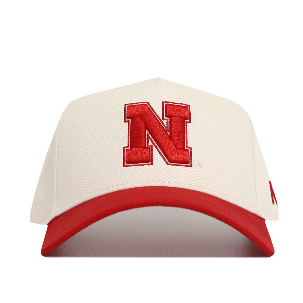 The No Rivals Classic University of Nebraska Hat (B2B) features a white cotton build, a bold red "N" on the front, and a matching red brim—combining lasting comfort with iconic style.