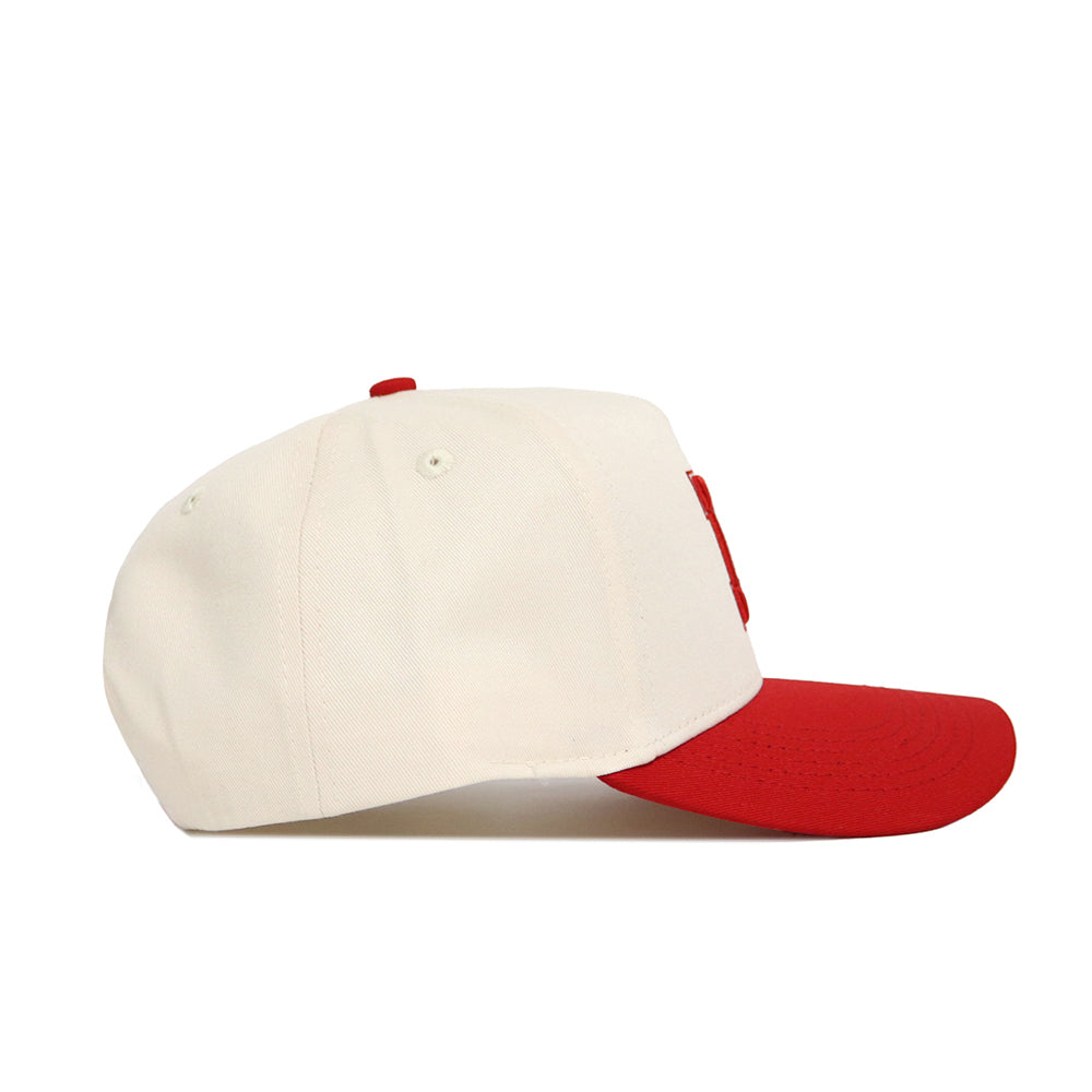 The Classic University of Nebraska Hat (B2B) by No Rivals is a white baseball cap with a red brim and top button, made from high-quality cotton and displayed in a side view against a plain white background.