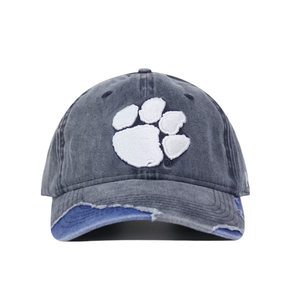 The Clemson Denim Hat is a faded black washed cotton dad hat with a white embroidered paw print on the front, frayed brim, and adjustable strap for comfort. Shown facing forward.