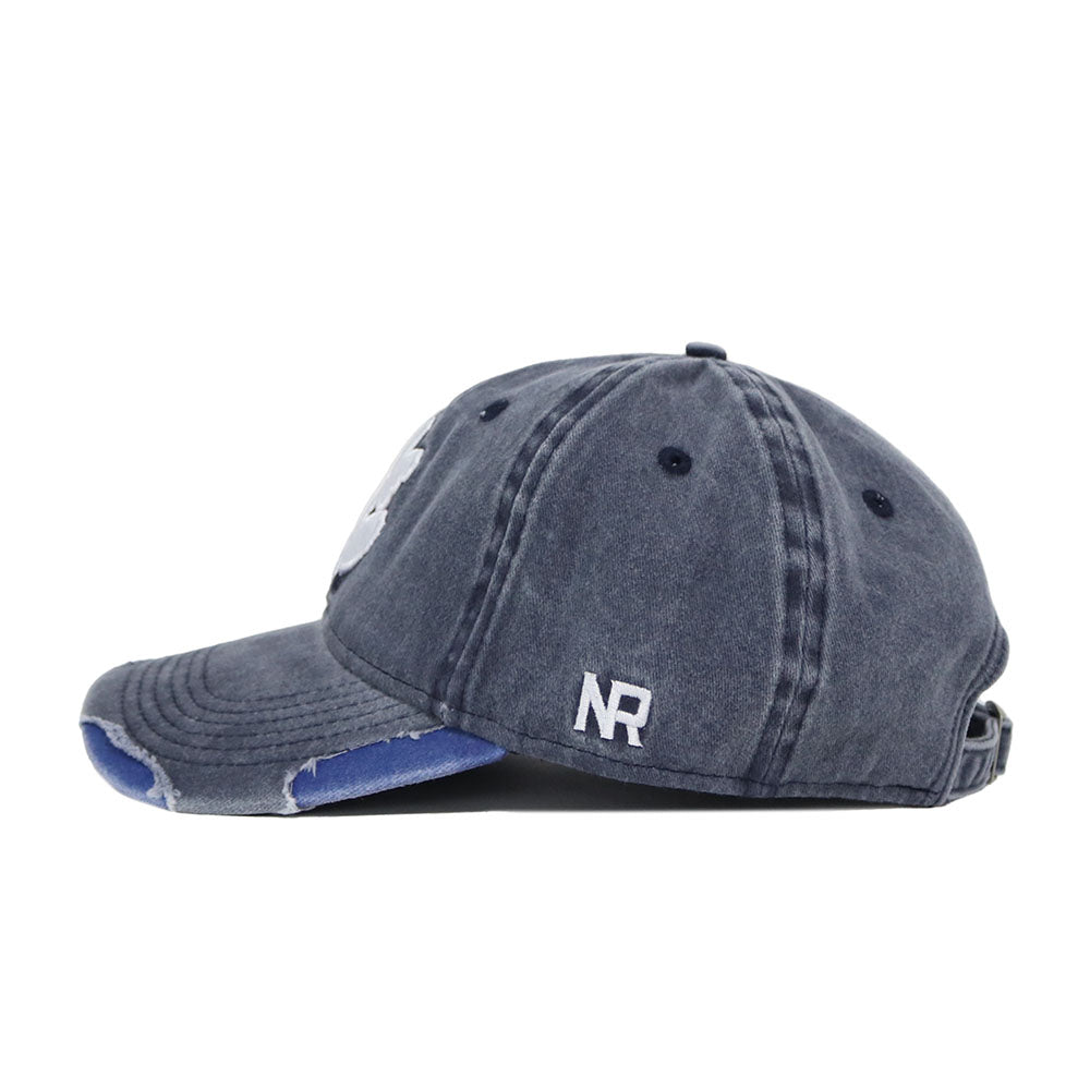 The Clemson Denim Hat is a dark blue, distressed dad hat in washed cotton with white NR embroidery on the side, worn edges on the curved brim, an adjustable strap, and ventilation eyelets on the crown.