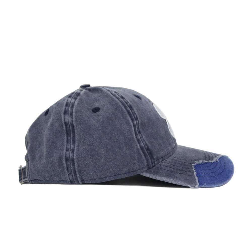 The Clemson Denim Hat is shown from the side with visible stitching, small ventilation holes, frayed brim edging, and an adjustable strap. Made of soft washed cotton for a relaxed look.