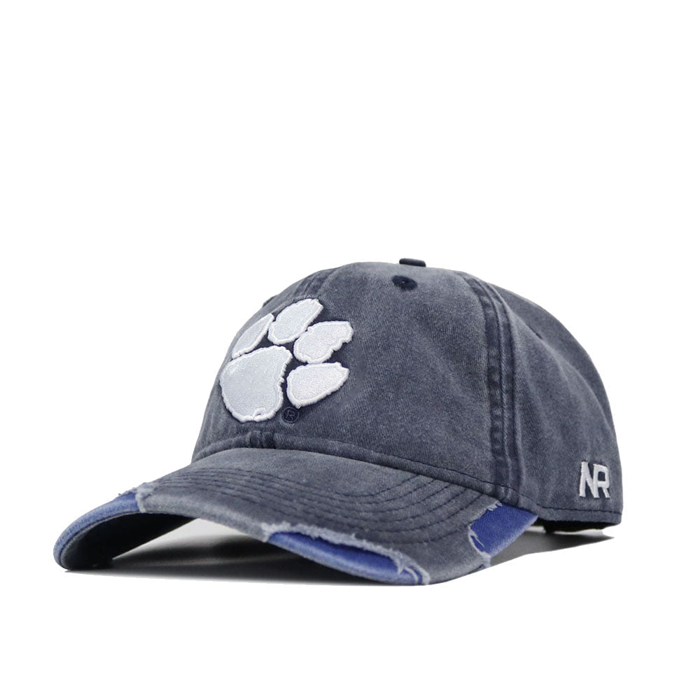 The Clemson Denim Hat is a blue washed cotton cap with a paw print design and an adjustable strap for comfort.