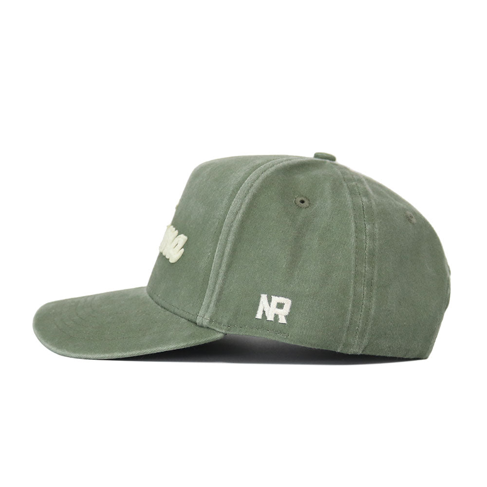 The Alabama Home Turf Hat is a green baseball cap with a curved brim, white embroidered NR letters on the side, stitched eyelets for ventilation, and a snapback closure for a comfortable, structured fit.