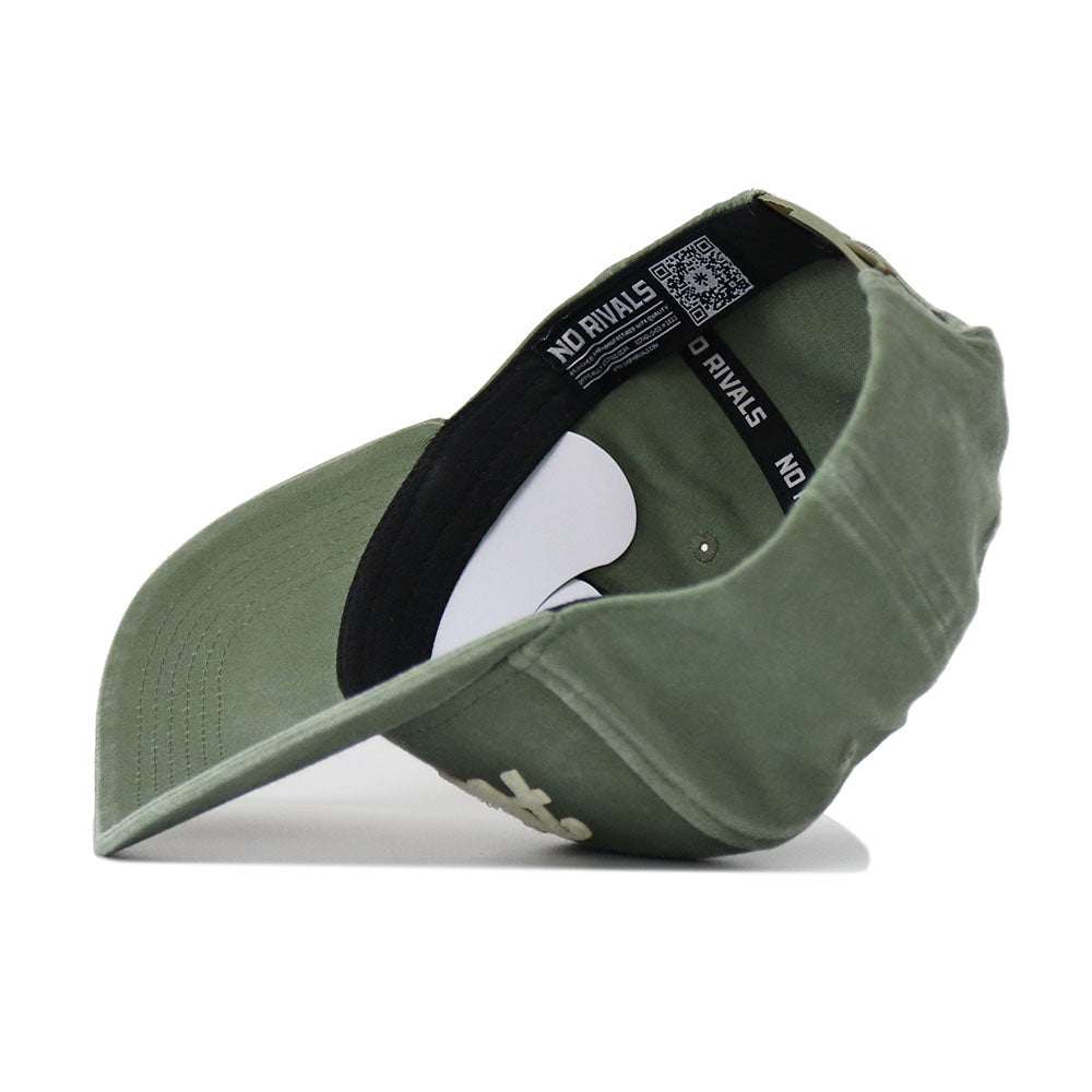 The Alabama Home Turf Hat is shown from a side angle, highlighting its green washed cotton material, inside lining, black inner band labeled NO RIVALS, and an adjustable back strap with a metal buckle.